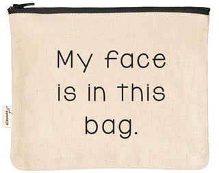 Natural canvas makeup bag with a black YKK zipper, printed in black with "my face is in this bag."