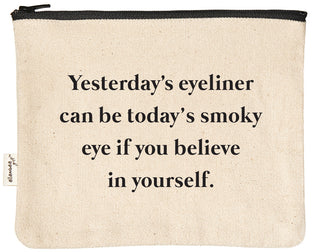 Canvas makeup bag printed with "yesterday's eyeliner can be today's smoky eye if you believe in yourself" in black text.