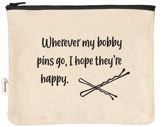 Canvas makeup bag printed with "Wherever my bobby pins go, I hope they're happy" in black text.