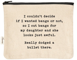 Natural canvas zipper pouch with a black YKK zipper, printed in black with "I couldn't decide if I wanted bangs or not, so I cut bangs for my daughter and she looks just awful. Really dodged a bullet there."
