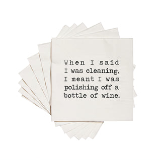 White cocktail napkin with the text 'When I said I was cleaning, I mean't I was polishing off a bottle of wine.' in black ink.
