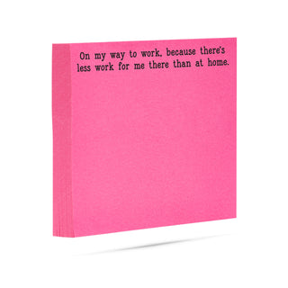 Neon pink sticky note with humorous text 'On my way to work, because there's less work for me there than at home.' printed in black ink.