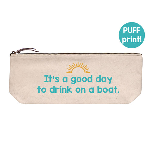 Cotton canvas zip pouch printed with "It's a good day to drink on a boat" and a sunshine design in teal and gold puff ink.