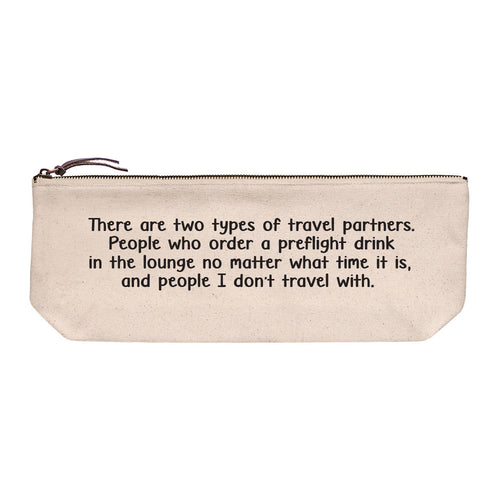 Cotton canvas zip pouch printed in black text reading "There are two types of travel partners. People who order a preflight drink in the lounge no matter what time it is, and people I don't travel with."