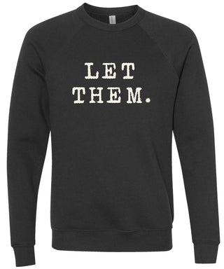 Black sweatshirt with 'Let them.' text printed in cream ink.