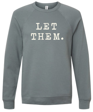 Storm sweatshirt with 'Let them.' text printed in cream ink.