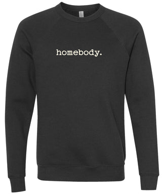 Black sweatshirt with 'homebody.' text in cream ink on a black sweatshirt. 