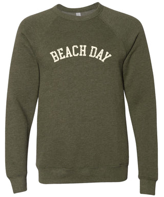 Heather olive colored sweatshirt with 'BEACH DAY' text printed in cream ink. 