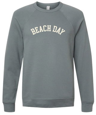 Storm colored sweatshirt with 'BEACH DAY' text printed in cream ink. 
