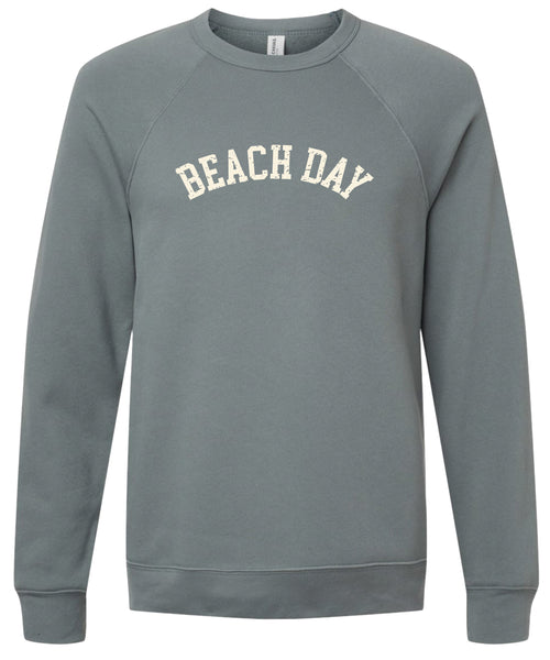 Storm colored sweatshirt with 'BEACH DAY' text printed in cream ink. 
