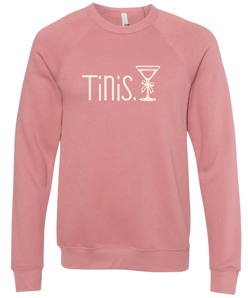 Pink sweatshirt with 'Tinis.' text and martini glass graphic printed in cream ink.