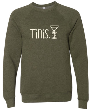 Olive green sweatshirt with 'Tinis.' text and martini glass graphic printed in cream ink.