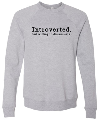 Light gray sweatshirt with text 'Introverted, but willing to discuss cats' printed in black ink.
