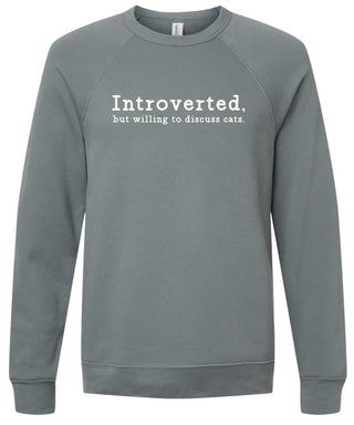 Storm sweatshirt with text 'Introverted, but willing to discuss cats' printed in cream ink.