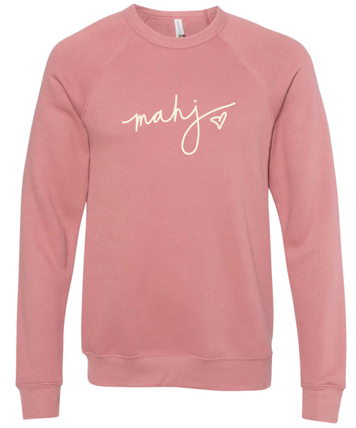 Pink sweatshirt with 'mahj' text with heart design in cream ink.