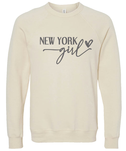 Cream sweatshirt with 'New York girl' printed in gray ink.