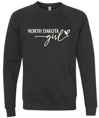 Heather black sweatshirt with 'North Dakota girl' printed in cream ink.