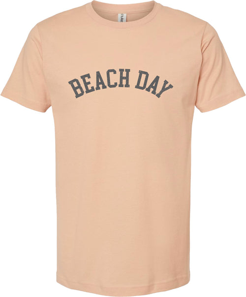 Peach t-shirt with 'Beach day' printed in gray ink.