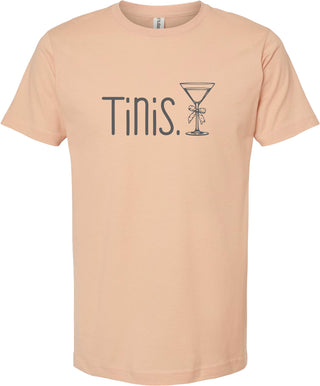 Peach t-shirt with 'Tinis.' and a martini glass graphic printed in gray ink.