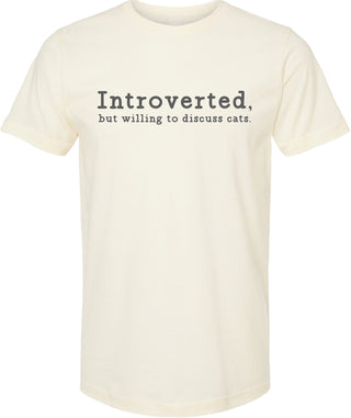 Cream t-shirt with text 'Introverted, but willing to discuss cats' printed in gray ink.
