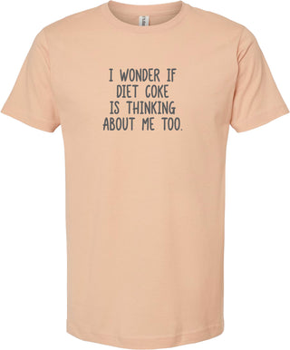 Peach t-shirt with humorous text 'I wonder if diet coke is thinking about me too' printed in gray ink.