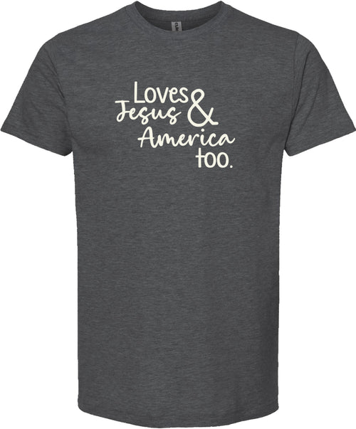 Dark gray t-shirt with text 'Loves Jesus & America too.' printed in cream ink.