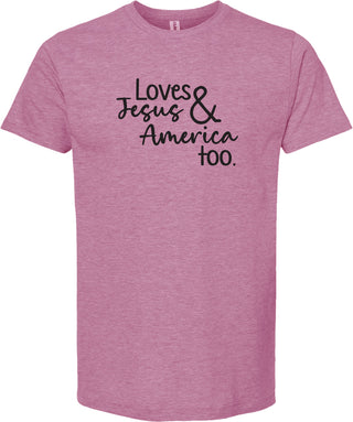 Raspberry t-shirt with text 'Loves Jesus & America too.' printed in black ink.