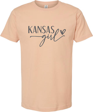 Peach t-shirt with 'Kansas girl' text on a white background