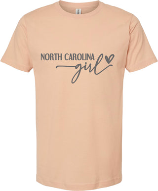 Peach t-shirt with 'North Carolina girl' text on a white background