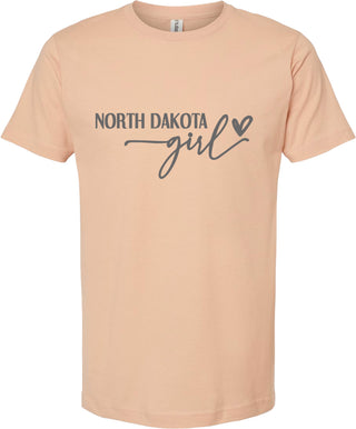 Peach t-shirt with 'North Dakota Girl' text on a white background