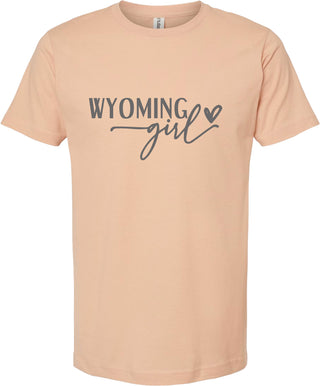Peach t-shirt with 'Wyoming girl' text on a white background