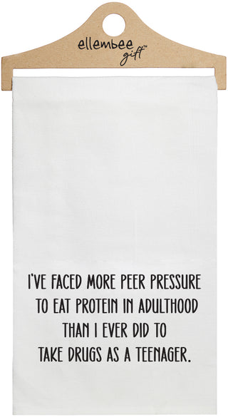 White towel with printed text 'I've faced more peer pressure to eat protein in adulthood than I ever did to take drugs as a teenager.' printed in black ink.