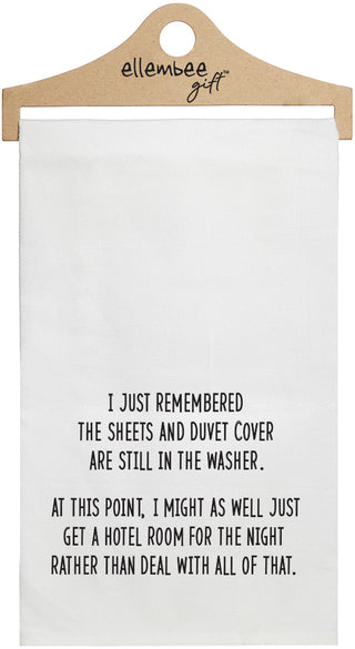 White towel with printed text 'I just remembered the sheets and duvet cover are still in the washer. At this point, I might as well just rent a hotel room for the night rather than deal with all of that.'  printed in black ink.