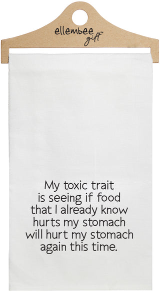 White towel with the text 'My toxic trait is seeing if food that I already know hurts my stomach will hurt my stomach again this time.'  printed in black ink.