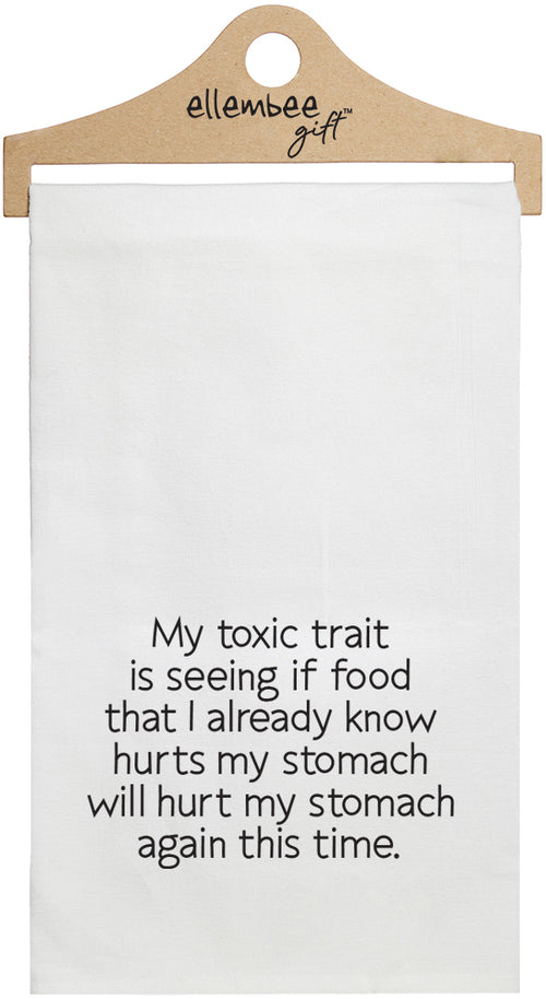 White towel with the text 'My toxic trait is seeing if food that I already know hurts my stomach will hurt my stomach again this time.'  printed in black ink.