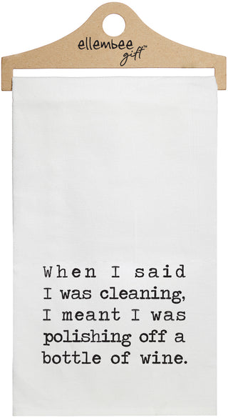 White towel with the text 'When I said I was cleaning, I mean't I was polishing off a bottle of wine.' printed in black ink.