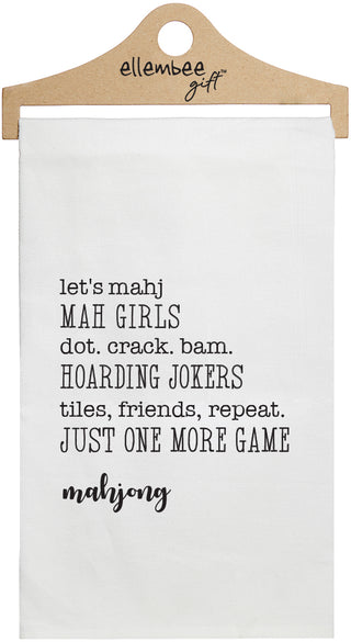 Mahjong text about mahjong game printed in black ink on a white cotton towel held by a wooden hanger.