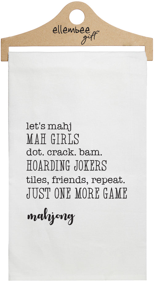 Mahjong text about mahjong game printed in black ink on a white cotton towel held by a wooden hanger.