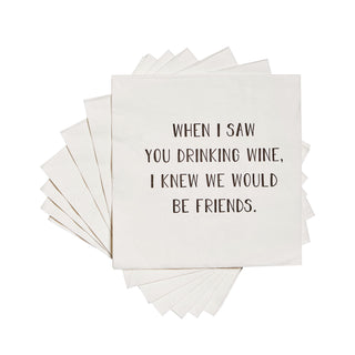 A stack of white 3-ply cocktail napkins printed in black with "When I saw you drinking wine I knew we would be friends."