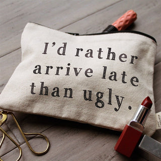 Lifestyle shot of the "arrive late than ugly" canvas makeup bag.