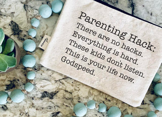 Parenting hack zipper pouch shown with everyday essentials tucked inside.