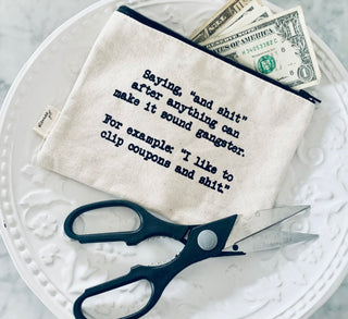 Lifestyle shot of the "and shit" canvas zipper pouch.