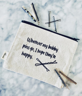 Lifestyle shot of the "bobby pins" canvas makeup bag.